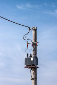 Low angle view of crane against sky