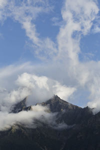 Low angle view of snowcapped mountains against sky