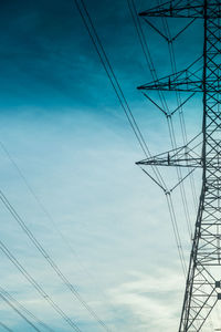 Low angle view of electricity pylon against sky