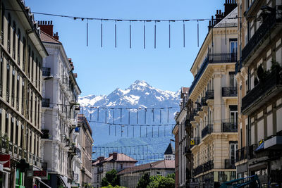 Buildings in city against sky during winter