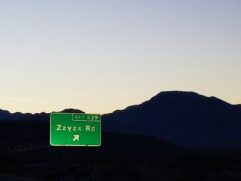 Road sign against clear sky