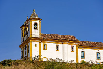 Low angle view of building against clear blue sky