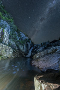 Scenic view of rock against sky at night