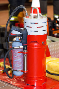 Close-up of red fire extinguisher on table