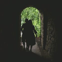 Full length rear view of woman in tunnel