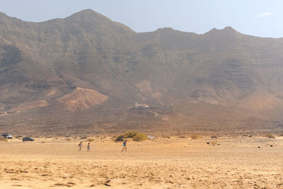 Scenic view of desert against mountain range