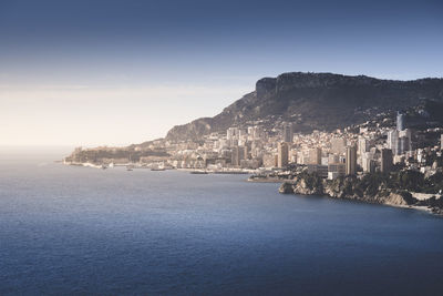 Scenic view of sea and buildings against sky