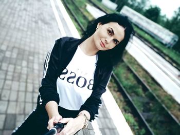 Portrait of woman standing against blurred background