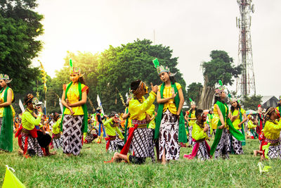 Panoramic view of people at park against sky