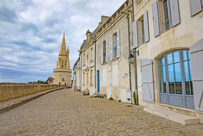 Street amidst buildings against sky in city