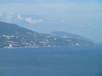 Scenic view of sea and city against sky