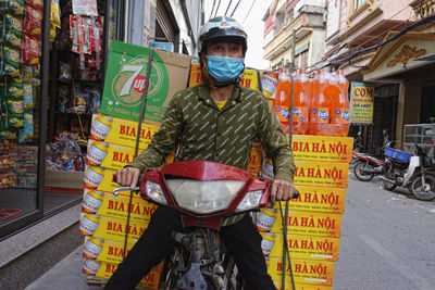 Portrait of man standing on street in city