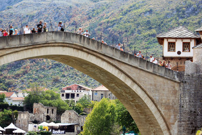 People walking on arch bridge