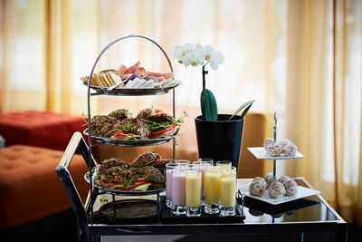 Meal arranged with flower vase over trolley in office during seminar