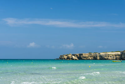 Scenic view of sea against blue sky