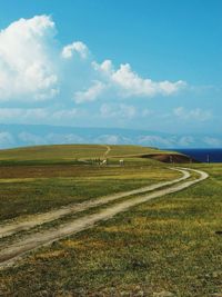 Scenic view of landscape against cloudy sky