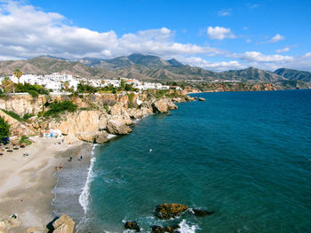 Scenic view of sea and mountains against sky