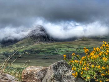 Scenic view of mountains against cloudy sky