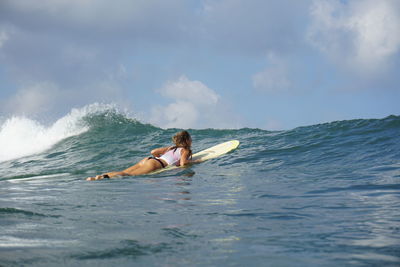 Woman surfing in sea