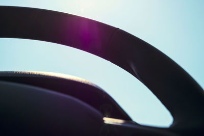 Close-up of car against blue sky