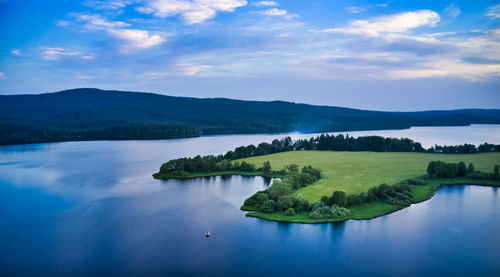 Scenic view of lake and mountains against sky