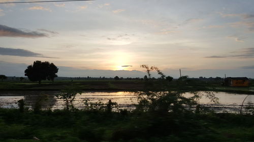 Scenic view of lake against sky during sunset