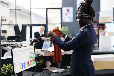 Side view of young man working in office