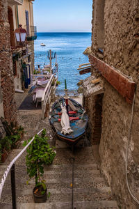 Boats moored on beach against sky