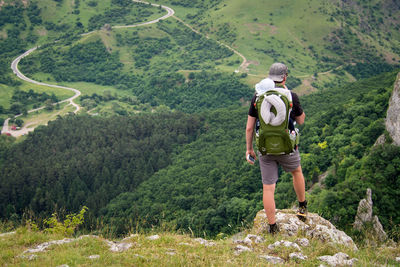 Rear view of people walking on mountain