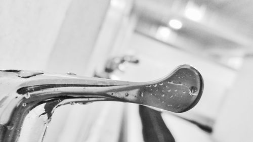 Close-up of water drop on faucet