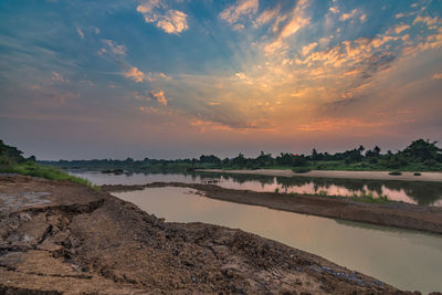 Scenic view of river against sky during sunset