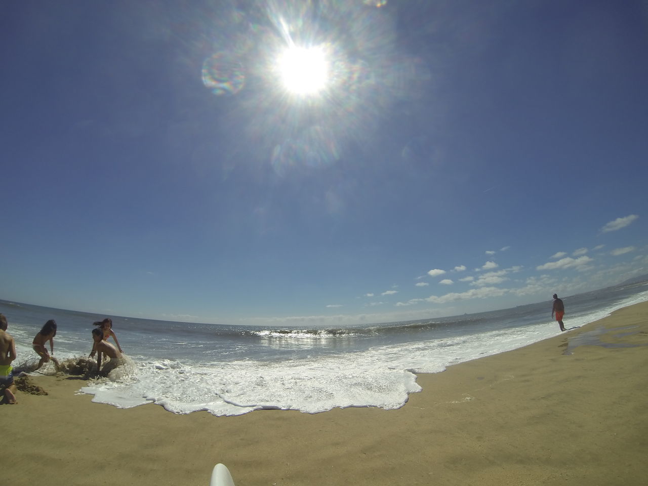 sea, beach, horizon over water, water, shore, sun, sky, sand, leisure activity, sunlight, lifestyles, sunbeam, vacations, scenics, men, beauty in nature, wave, large group of people, tranquility