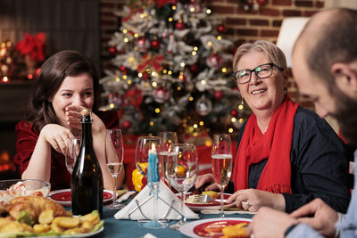 Portrait of young woman having food at home