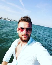 Portrait of young man against sea