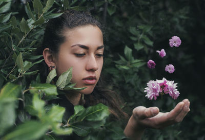 Portrait of young woman with flowers