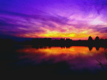 Scenic view of calm lake at sunset