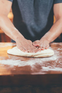 Midsection of person preparing food at table