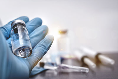 Close-up of hand holding bottle
