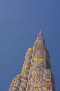 Low angle view of modern building against clear blue sky