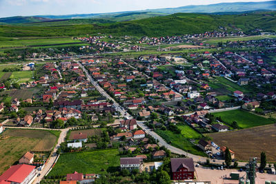 High angle view of houses on field against sky