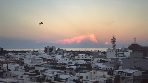 Cityscape against sky during sunset