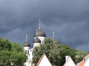 Panoramic view of buildings and trees against sky