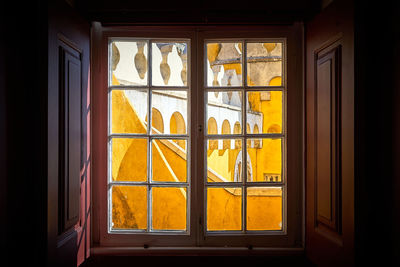 Close-up of yellow window in house