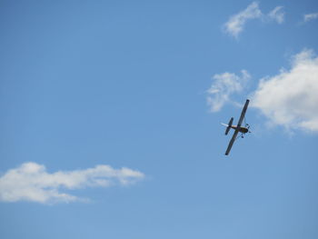 Low angle view of airplane against sky