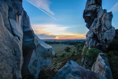 Scenic view of rock formation against sky during sunset