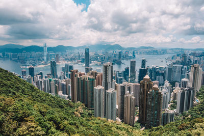 High angle view of cityscape against cloudy sky