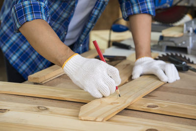 Midsection of man working on table