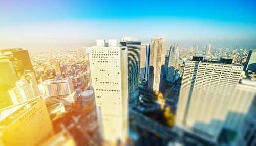 Aerial view of modern buildings in city against sky