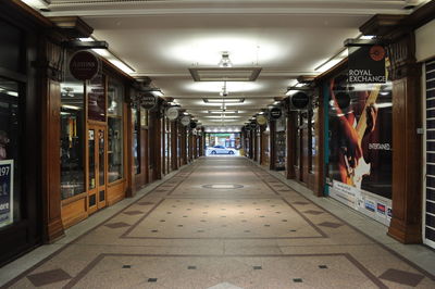 Interior of illuminated corridor in shopping mall