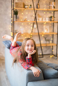 Portrait of smiling girl sitting on floor